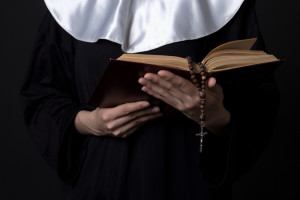 Nun,Hands,Holding,Bible,Book,Over,Grey,Background